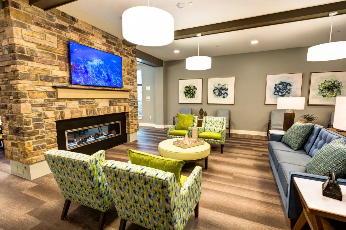 A modern living room with stylish furniture and a cozy fireplace.