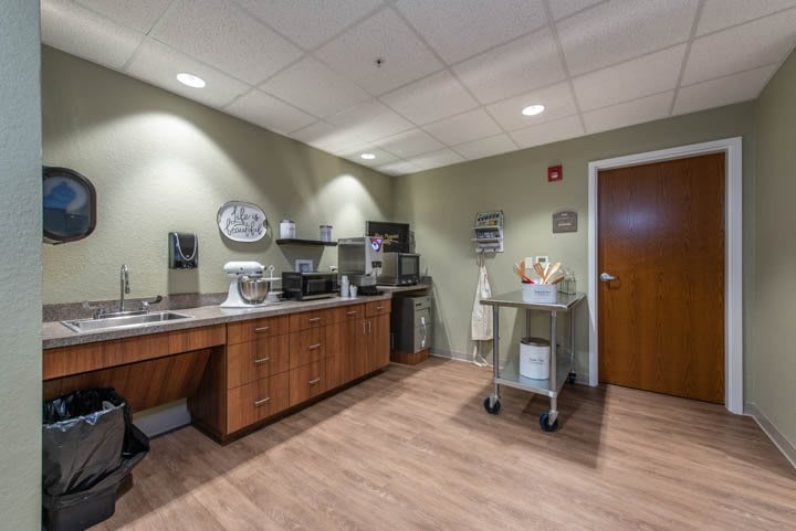Office breakroom with appliances and cabinets.