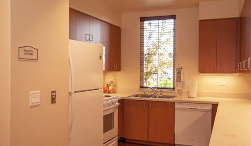 A cozy modern kitchen featuring essential appliances and natural light.