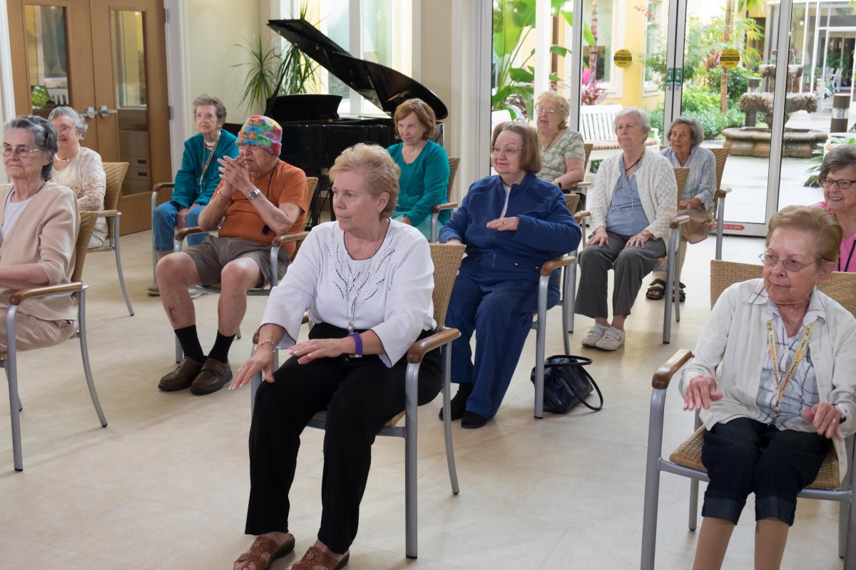 A group of seniors participating in an indoor exercise session.