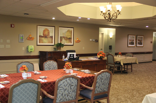 A cozy dining area with well-set tables and artistic decor.