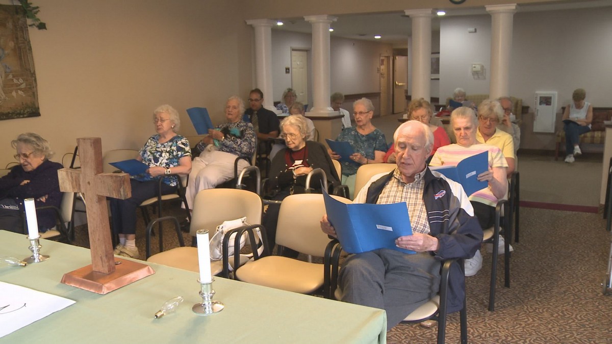 A group of seniors engaged in a musical activity indoors.