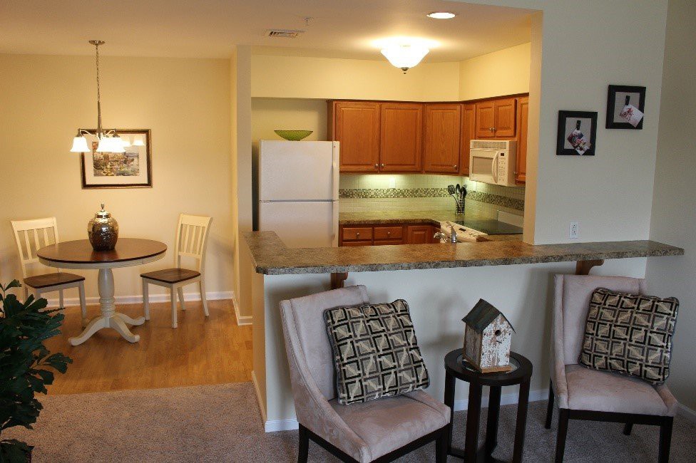An open floor plan apartment with a view of the kitchen, dining area, and living space.