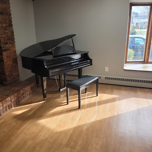 A grand piano positioned gracefully in a well-lit room, inviting a serene musical experience.