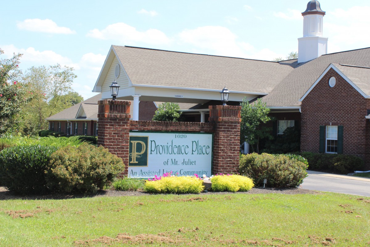 Entrance sign at Providence Place of the Pines property.