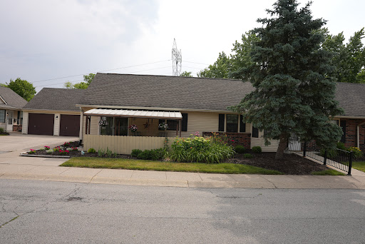 A cozy suburban house with a well-maintained front yard.