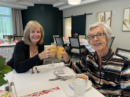 Two friends enjoying a cheerful brunch together.