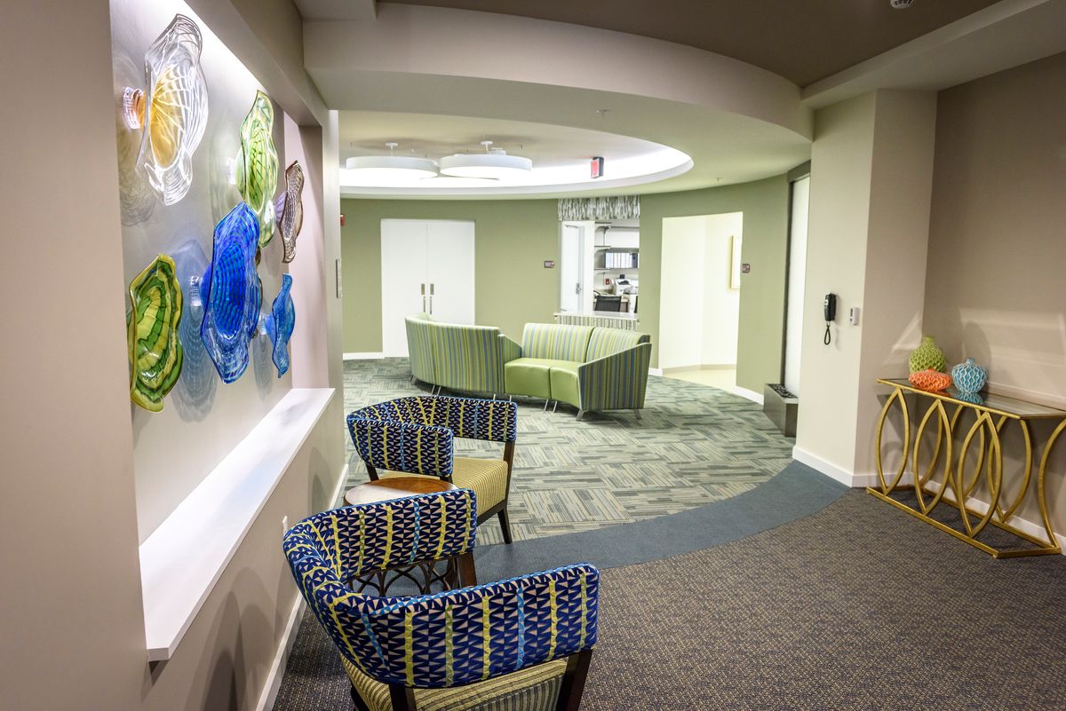 A modern lobby area with comfortable seating and decorative artwork on the wall.