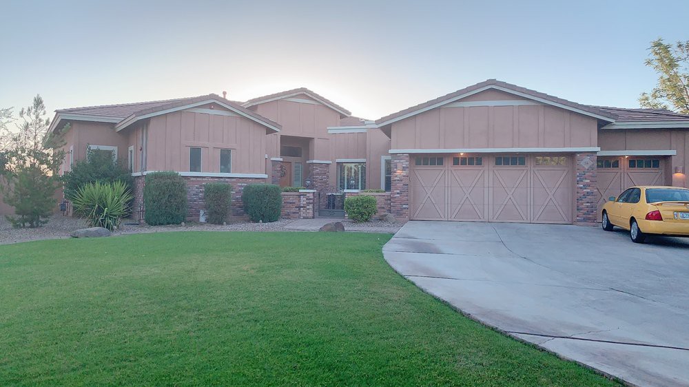 A suburban house with a brick exterior and a neatly maintained front yard.