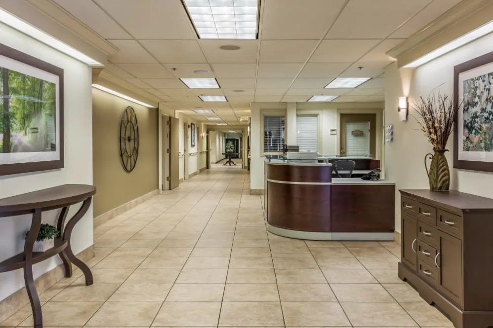 A hospital corridor with a reception desk.