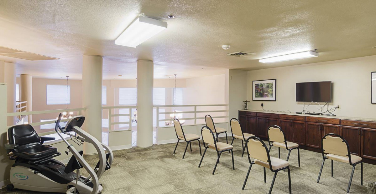 A small meeting room with chairs arranged in a row, suitable for conferences or presentations.