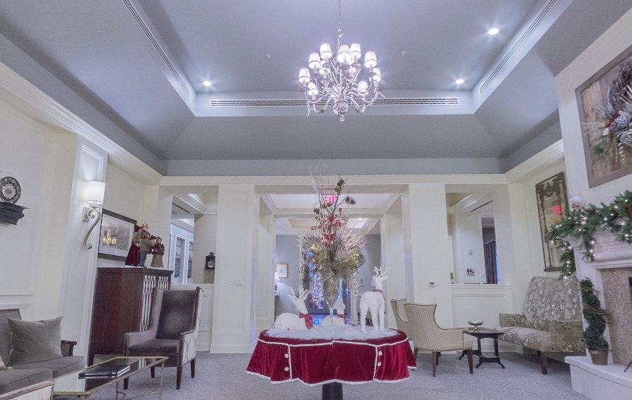 A tastefully decorated living room featuring a chandelier and elegant furnishings.