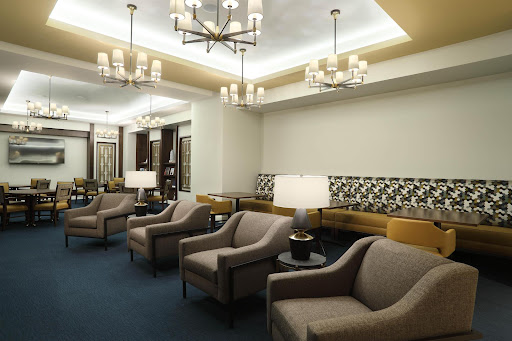 A cozy lounge area featuring modern furniture and ambient lighting.