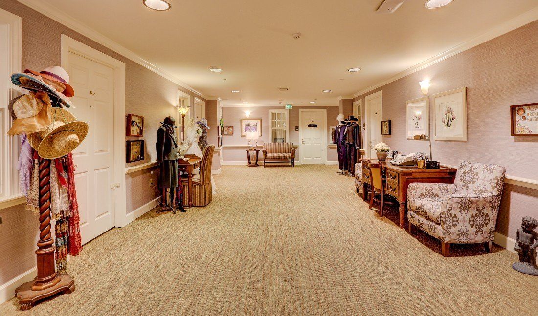 A well-decorated hallway with furniture and subtle lighting.