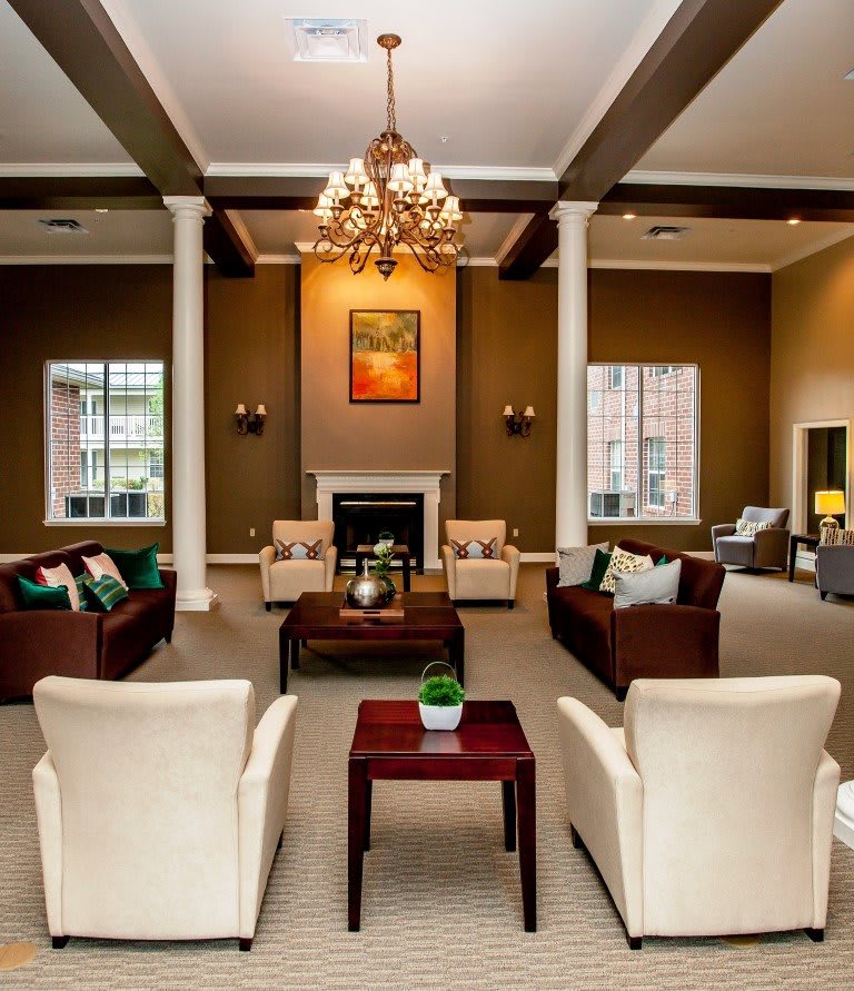 Spacious lounge with elegant furniture and a chandelier.