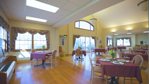 A spacious dining area featuring elegantly set tables and abundant natural light.