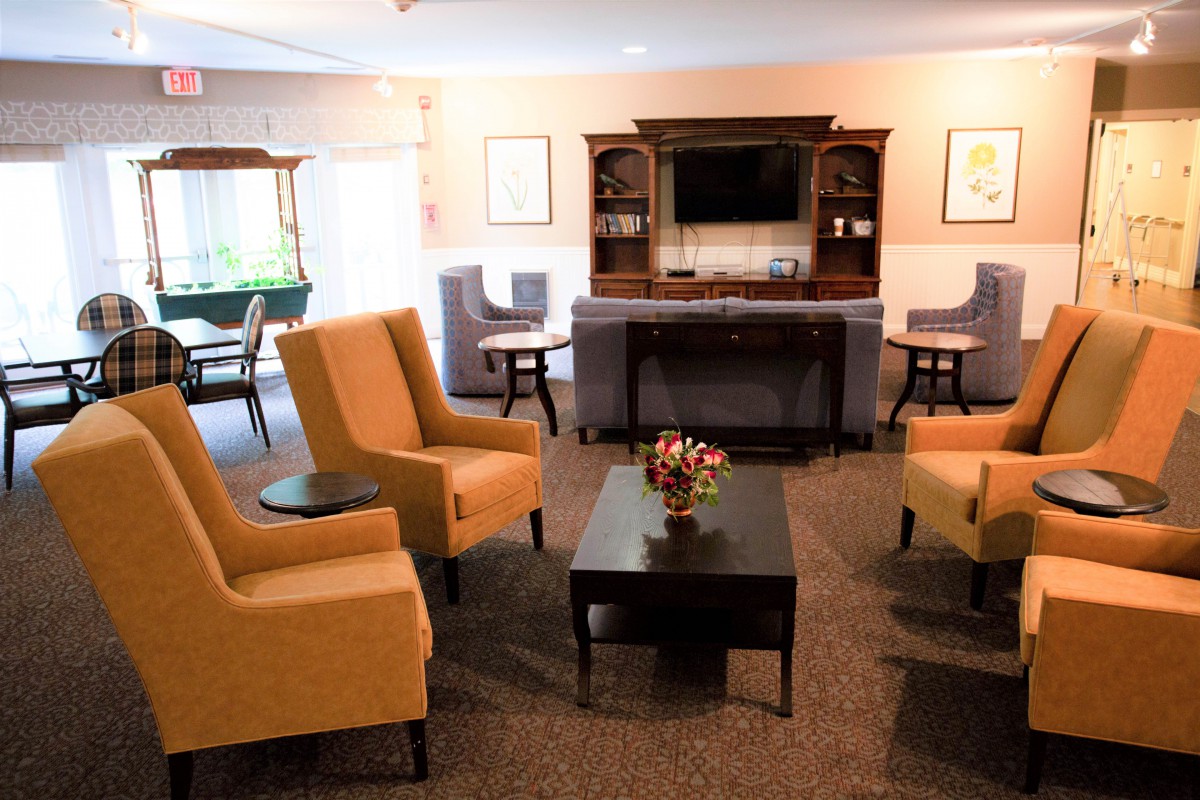 A cozy living room with comfortable seating, a coffee table, and a television.