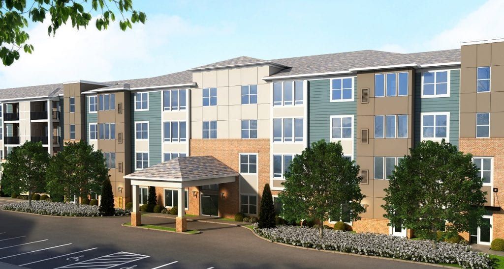 A modern, multi-story residential building with a mix of colors and landscaping.