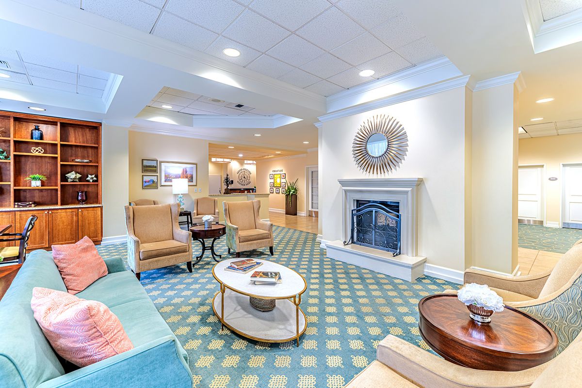 A cozy and elegantly designed living room featuring a fireplace, comfortable seating, and stylish decor.