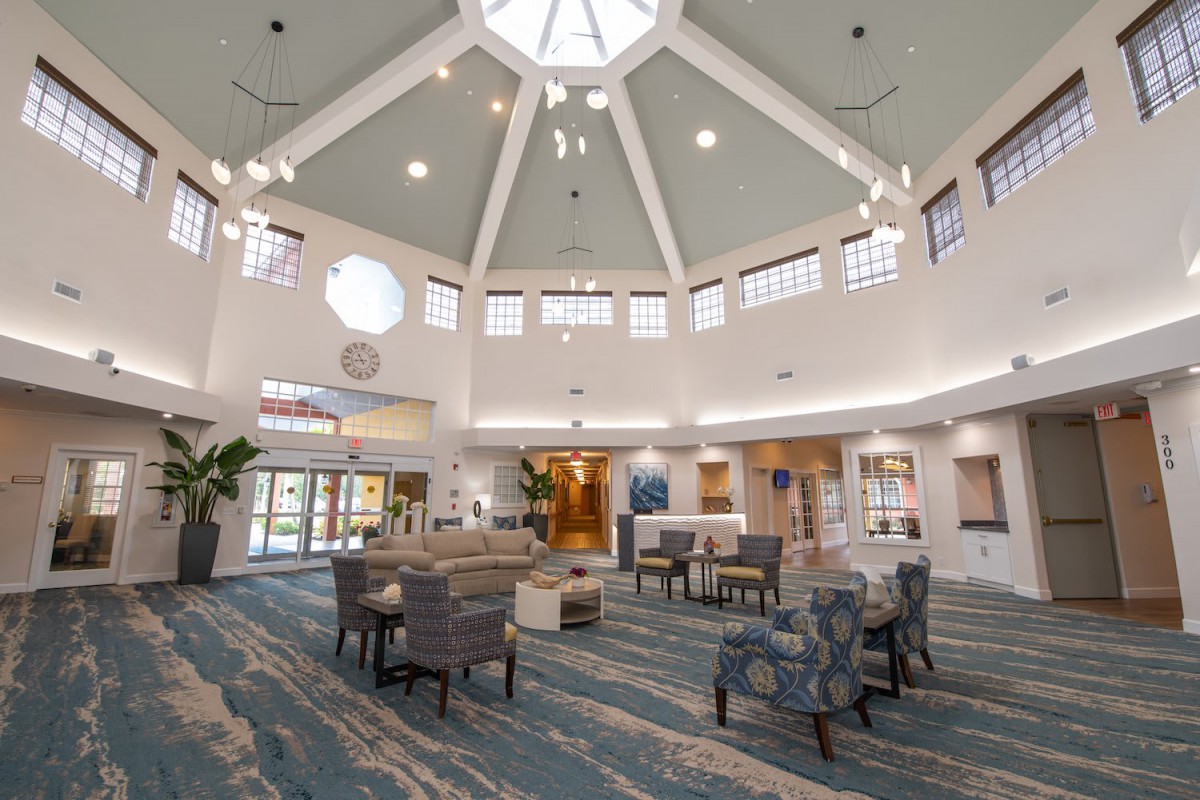 A modern lobby with comfortable seating and a high ceiling with abundant natural light.