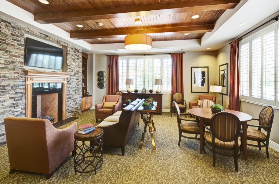 A cozy living room with a fireplace, comfortable seating, and elegant decor.