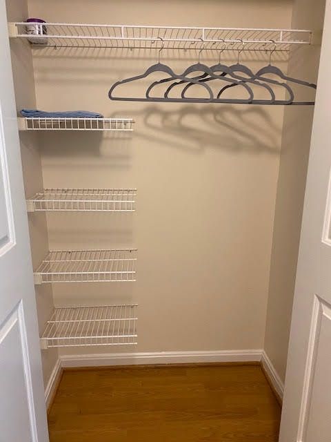 An empty closet with wire shelves and hangers.