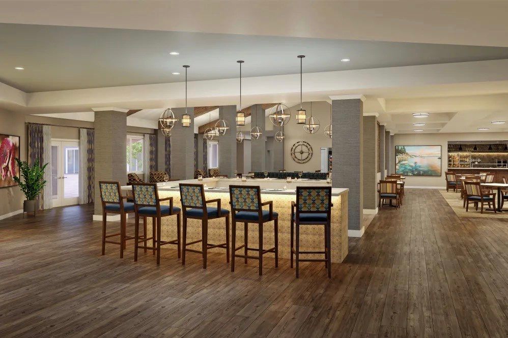 A modern bar interior with high chairs and elegant pendant lighting.