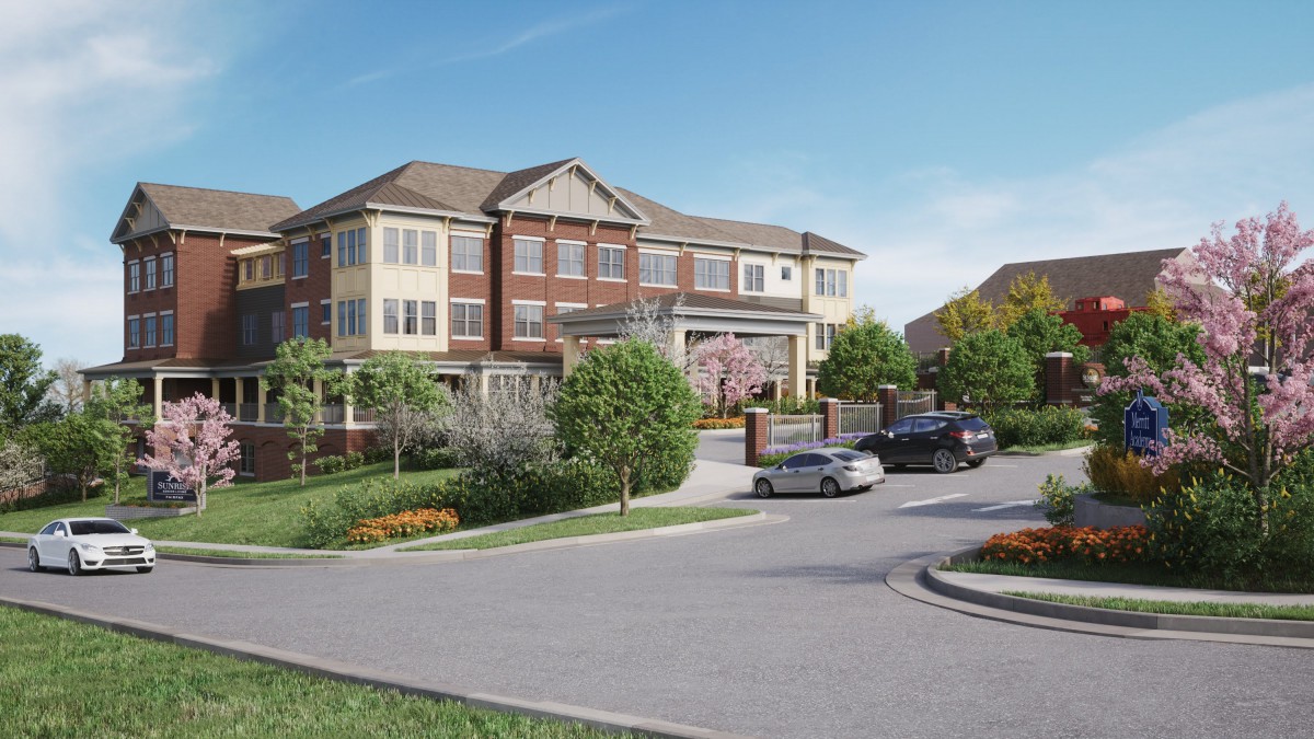 A picturesque residential building surrounded by a lush landscape with parked cars in the driveway.