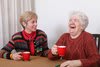 Two seniors enjoying a laugh over coffee.