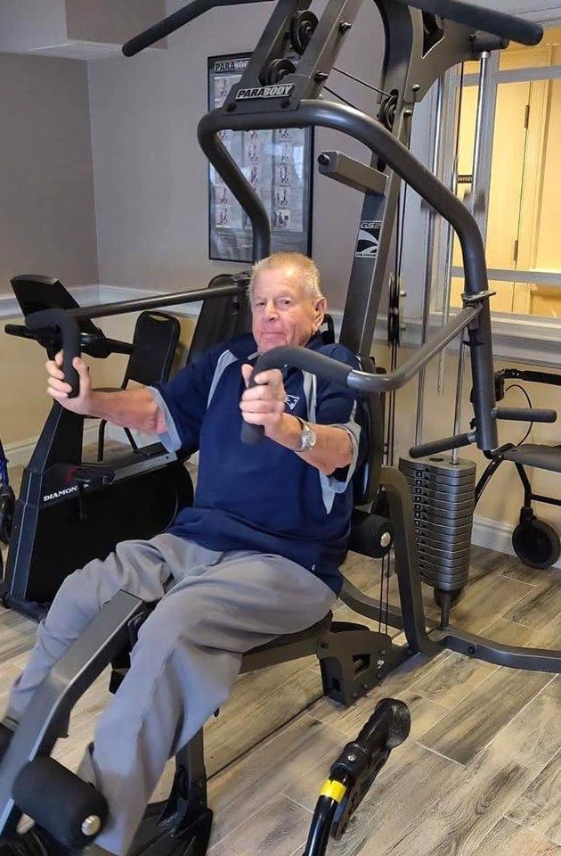 A senior person using gym equipment for strength training.