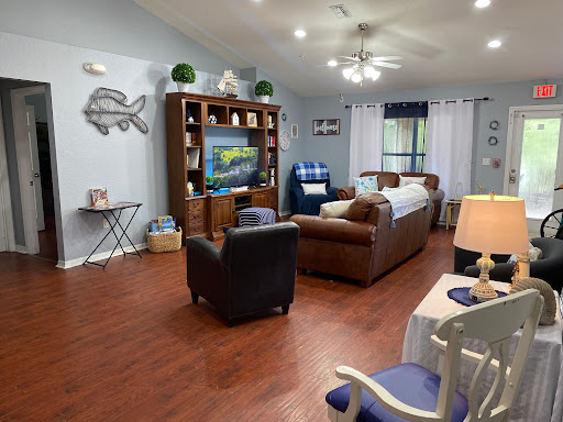 A cozy living room featuring comfortable seating, a television set, and tasteful decor.