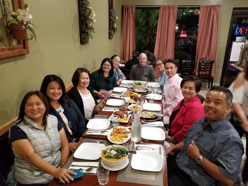 A group of friends gathered around a table for dinner at a restaurant.