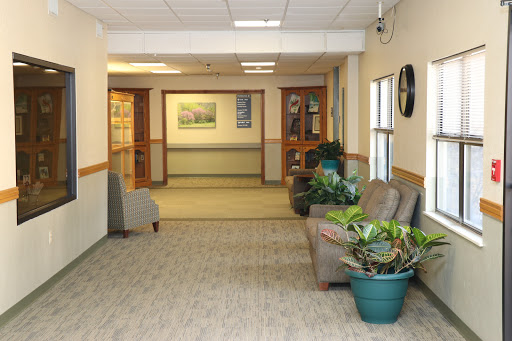 A welcoming hallway featuring comfortable seating and decorative plants.