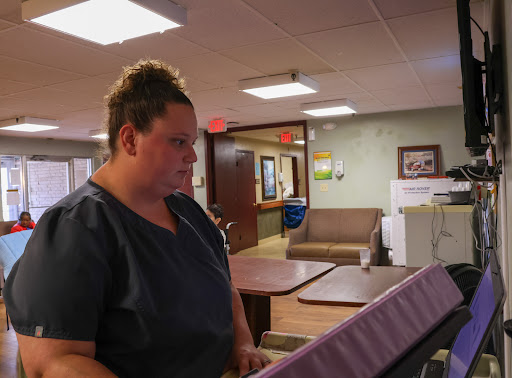 A nurse engaged in her work at a healthcare facility.