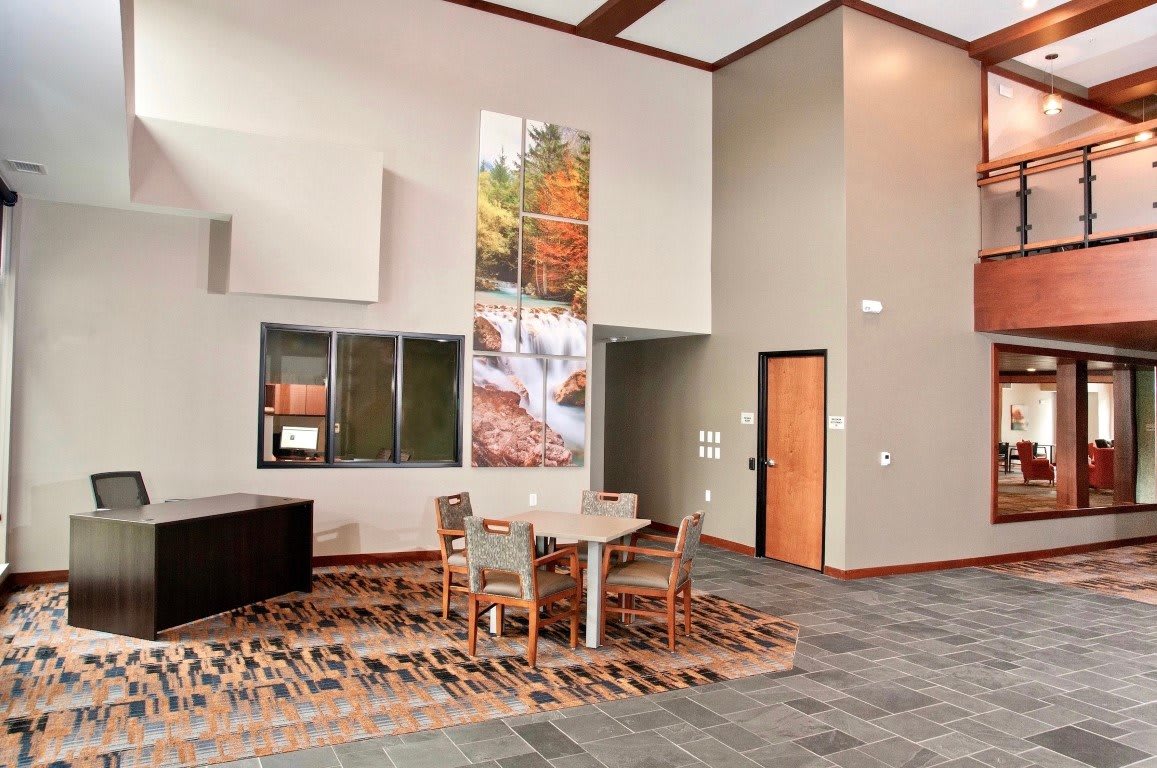 A modern lobby with a seating area, decorated with artwork and contemporary furniture.