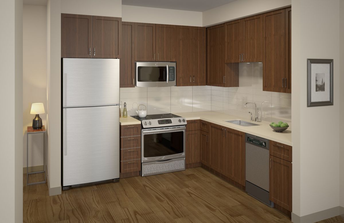 A modern kitchen with wood cabinets and stainless steel appliances.