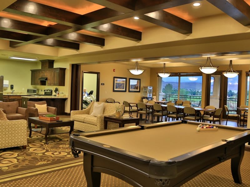A stylish and cozy recreation area featuring a pool table and comfortable seating.