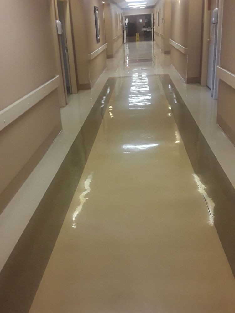 A shiny corridor in a hospital with beige walls.