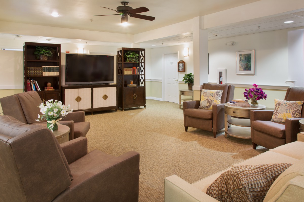 A cozy living room with comfortable seating, a large television, and elegant decor.