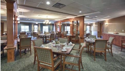A cozy dining area with neatly set tables and comfortable seating.