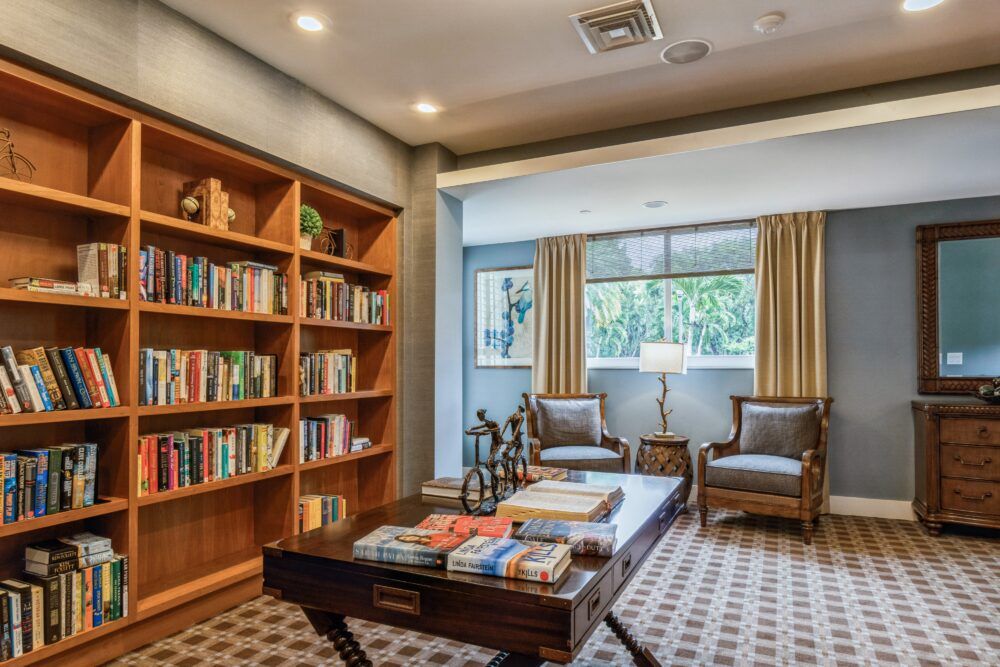 A cozy library reading area with bookshelves and comfortable seating.