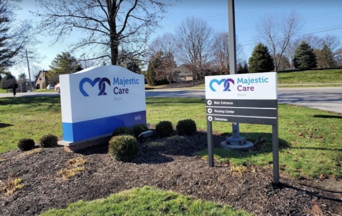 Outdoor signs for Majestic Care with landscaped surroundings.