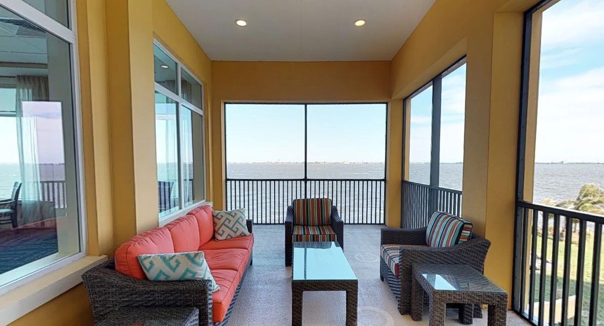 A cozy balcony with comfortable seating and a stunning ocean view.