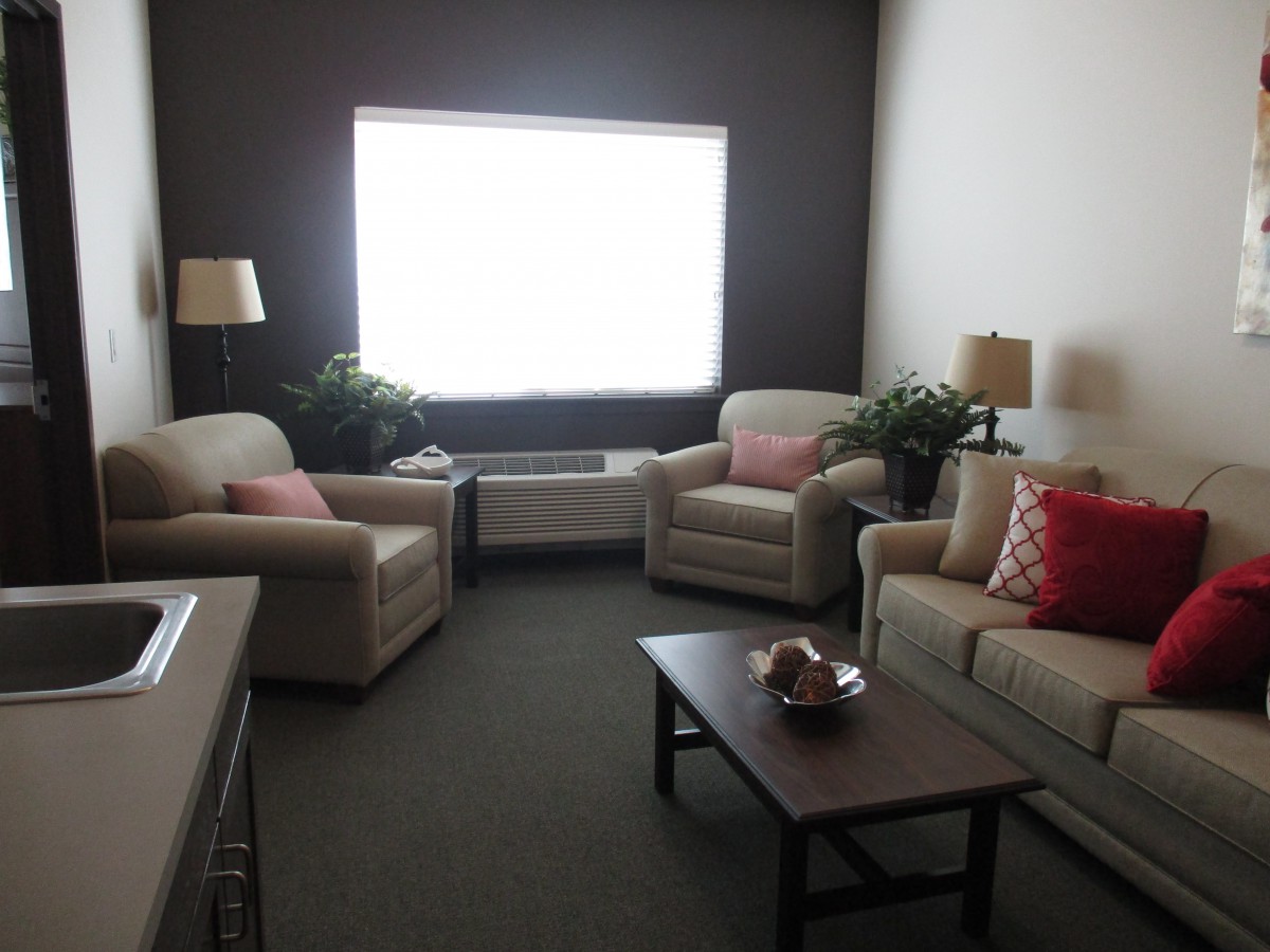 A cozy living room with comfortable seating and a large window.