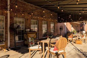Cozy patio with string lights and comfortable outdoor seating.