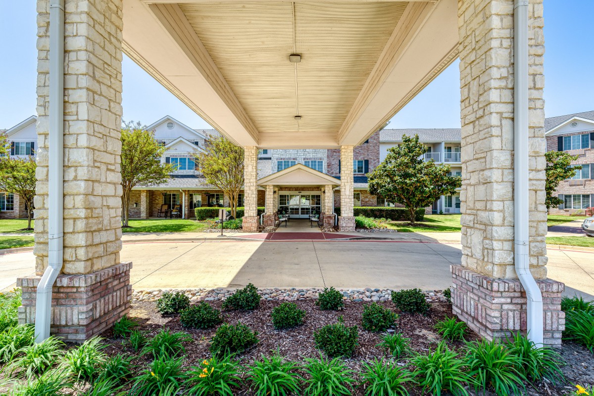 A welcoming building entrance with a landscaped pathway.