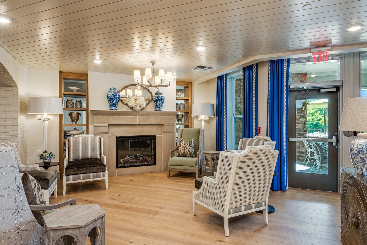 A cozy living room with modern decor, featuring a fireplace and comfortable seating.