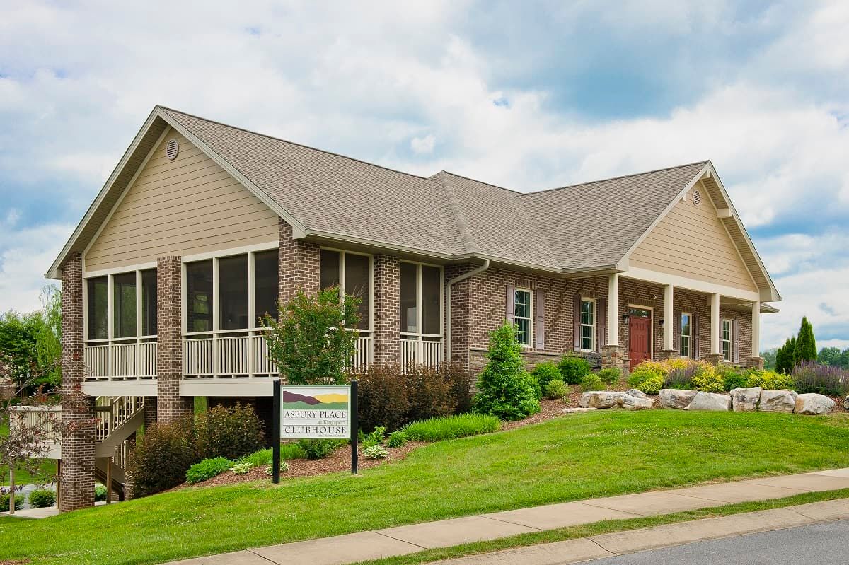 A suburban house with a brick exterior and landscaped front yard.