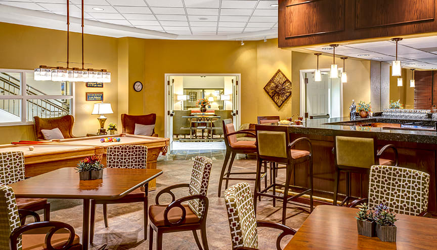 A cozy lounge area with a bar, featuring comfortable seating and stylish decor.