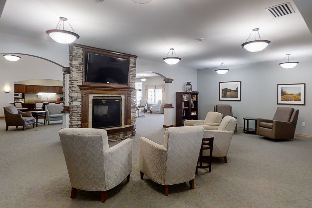 A modern living room with comfortable seating, a television, and a fireplace.